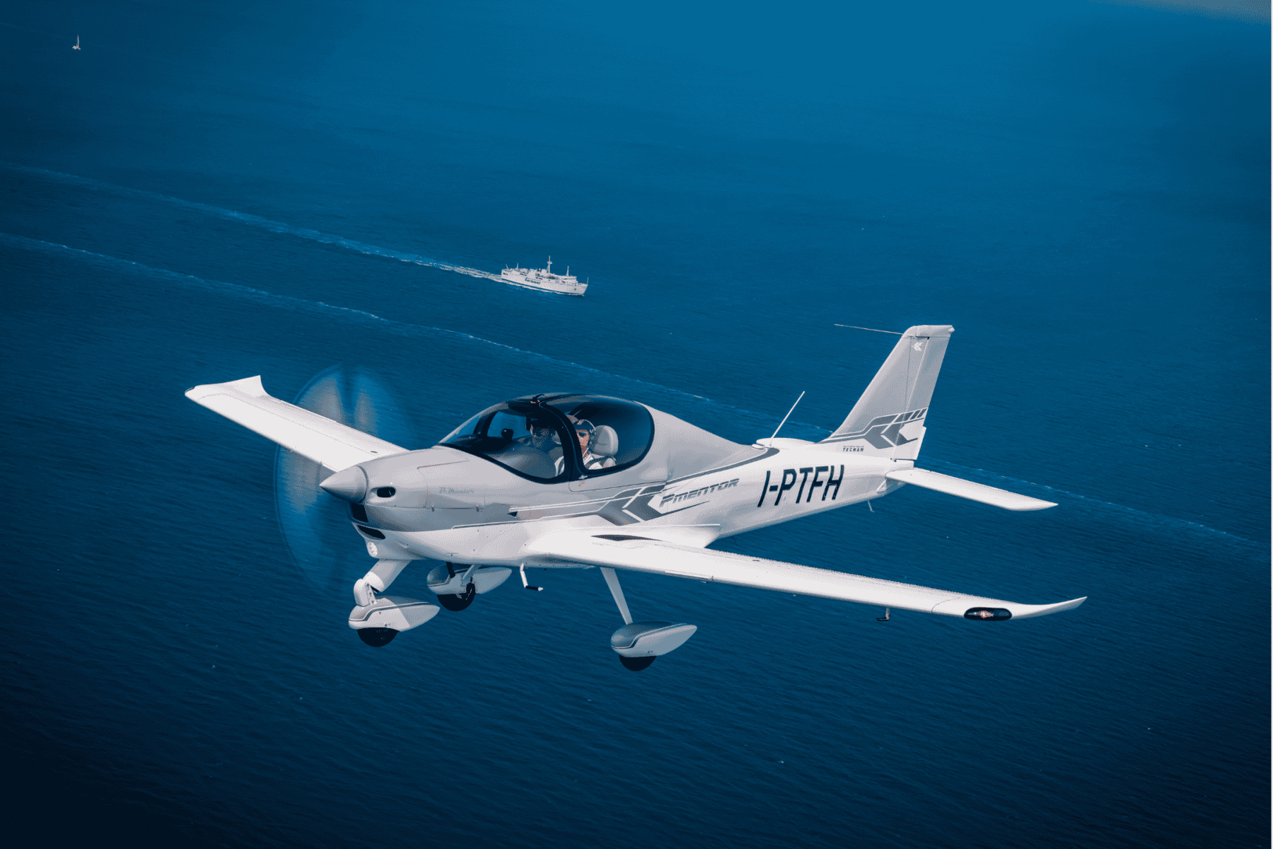 Small airplane flying over ocean
