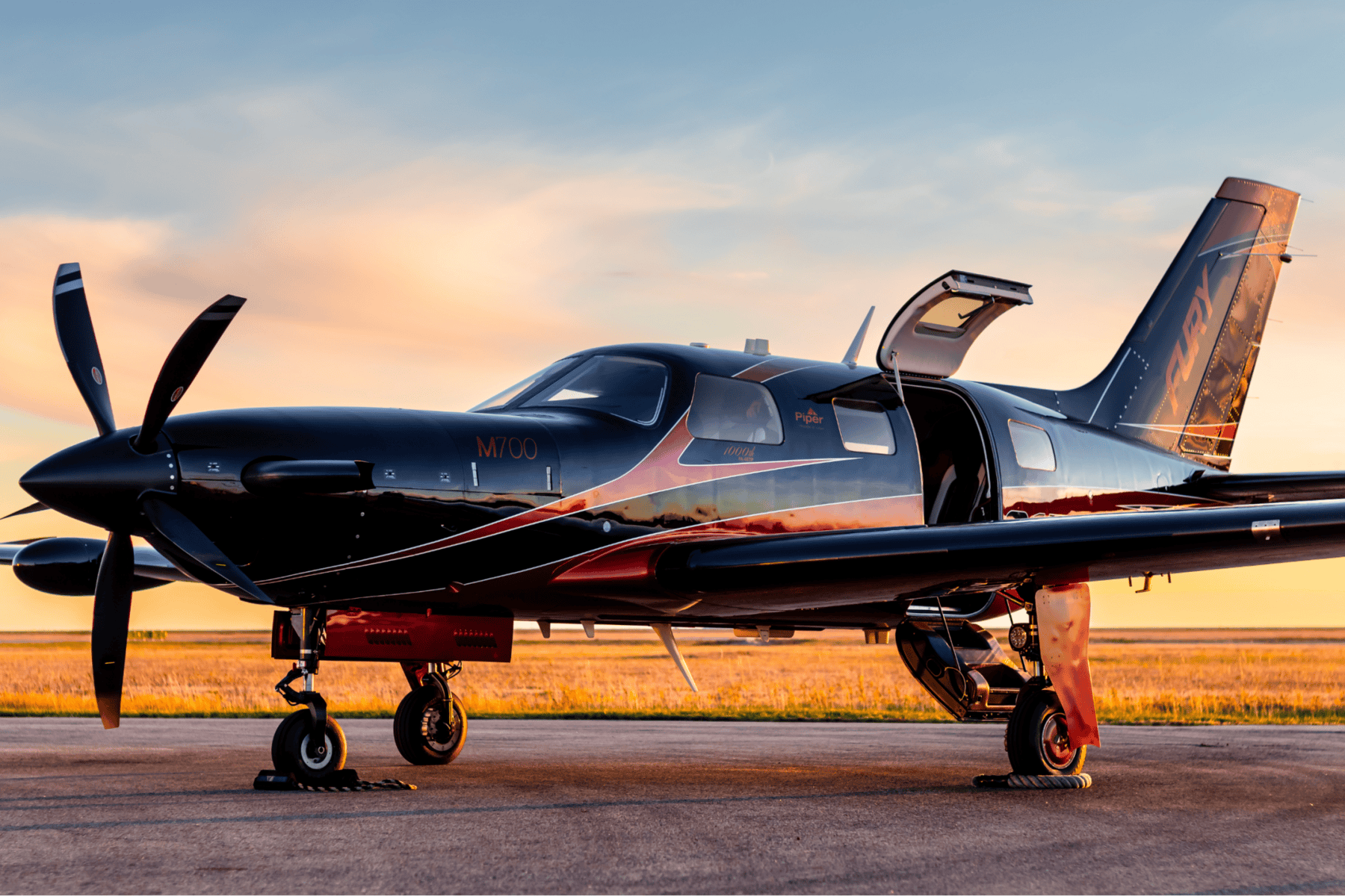 Small aircraft on runway at sunset