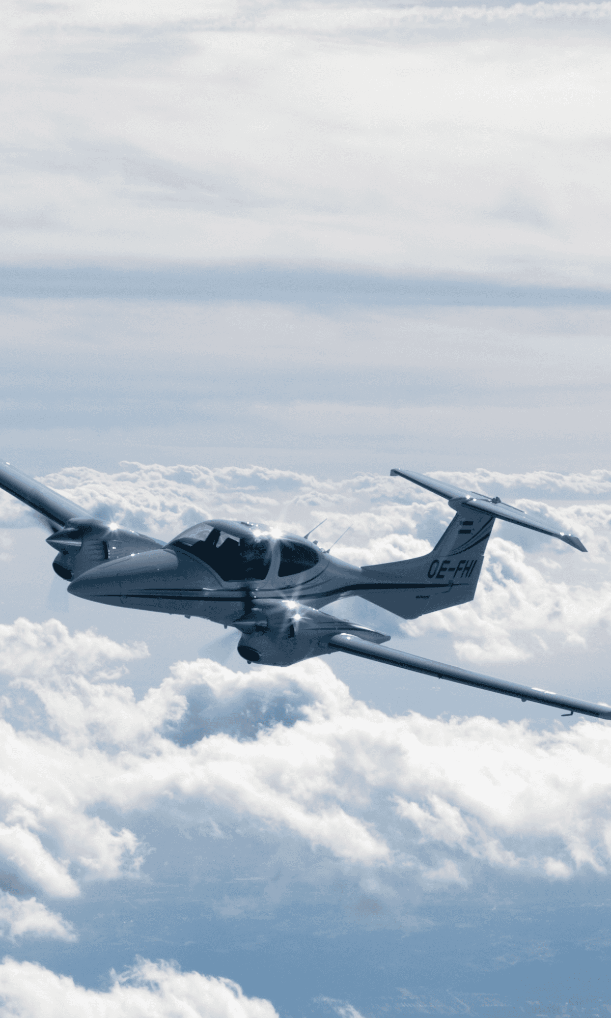 Small aircraft flying above clouds