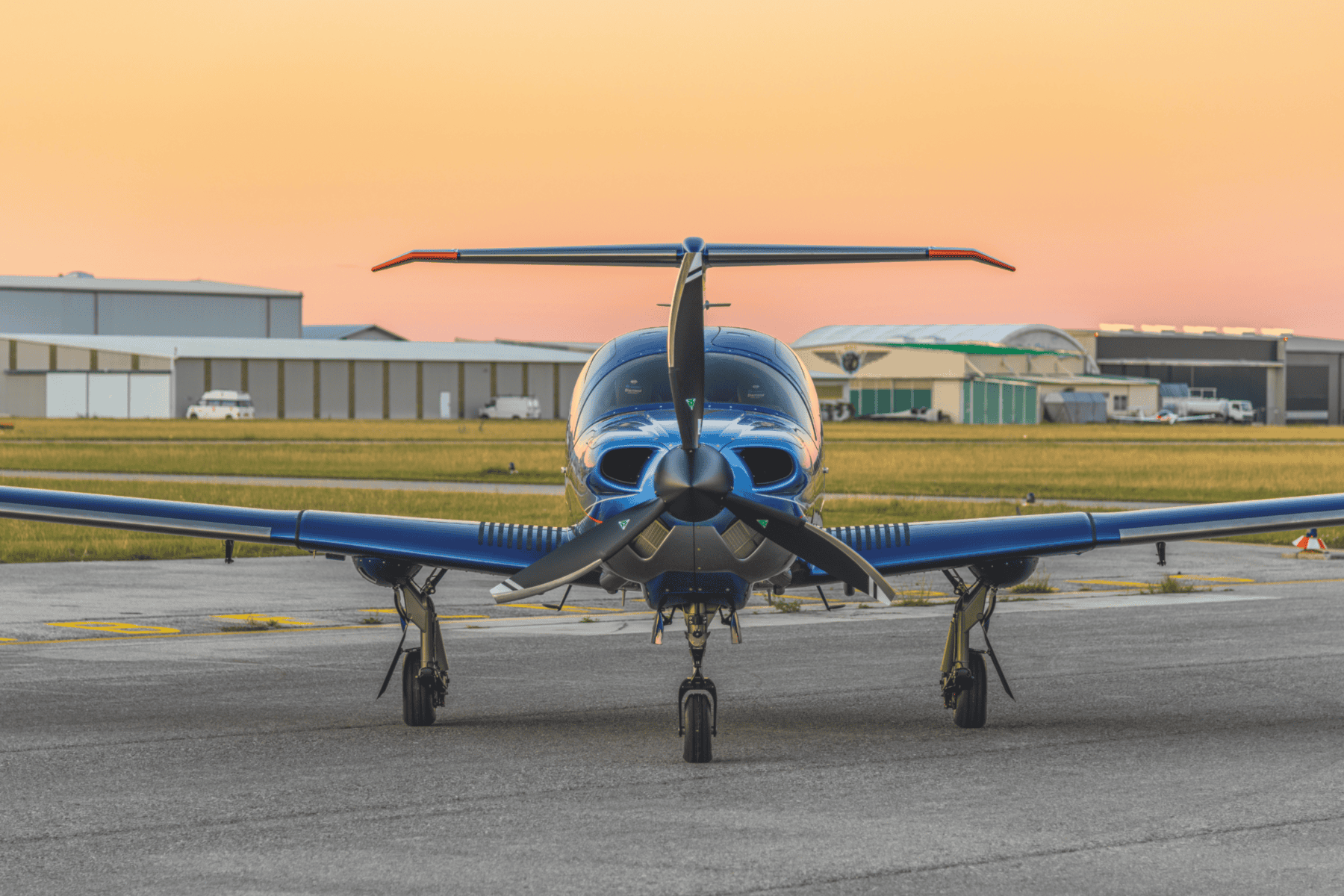 Small aircraft on runway at sunset