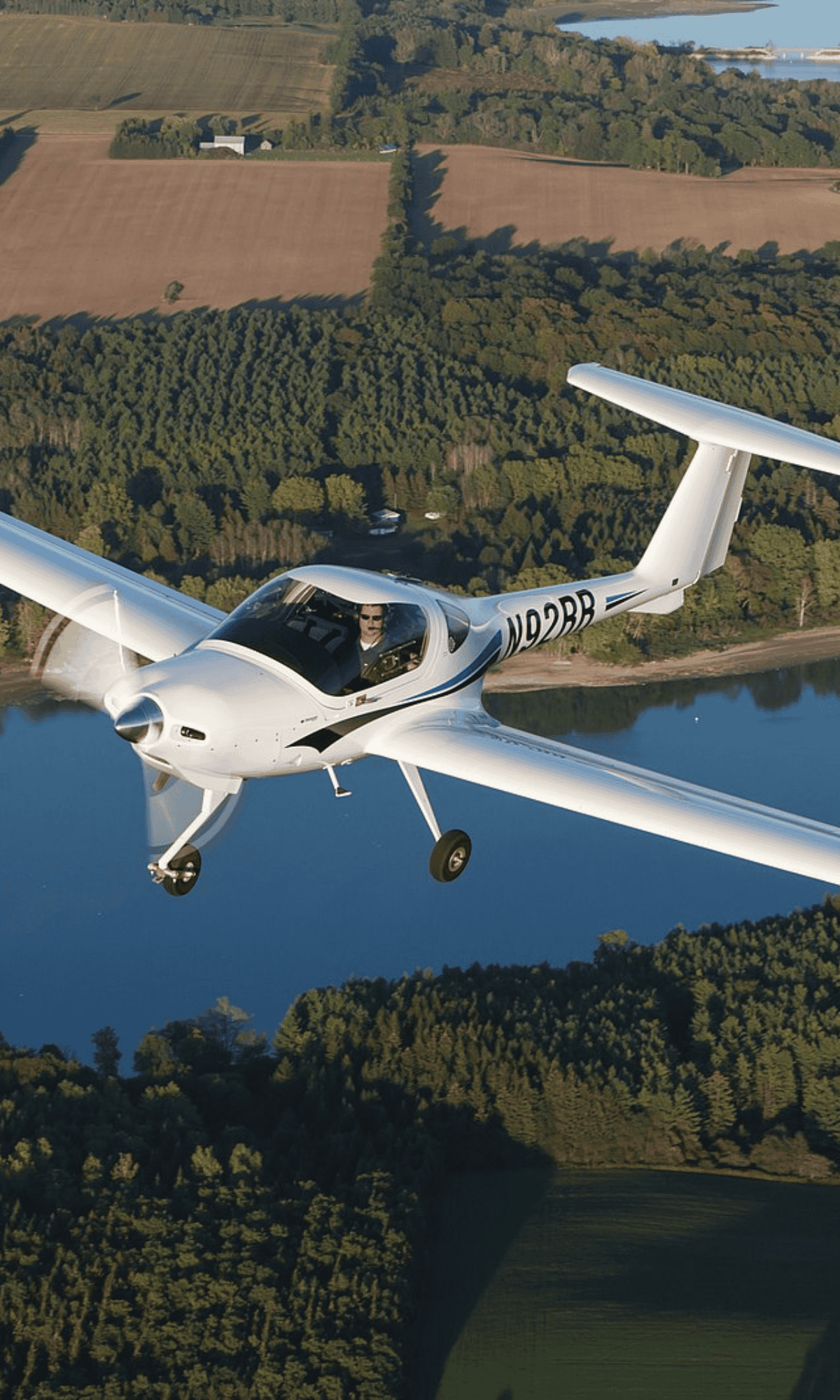 Small airplane flying over scenic landscape