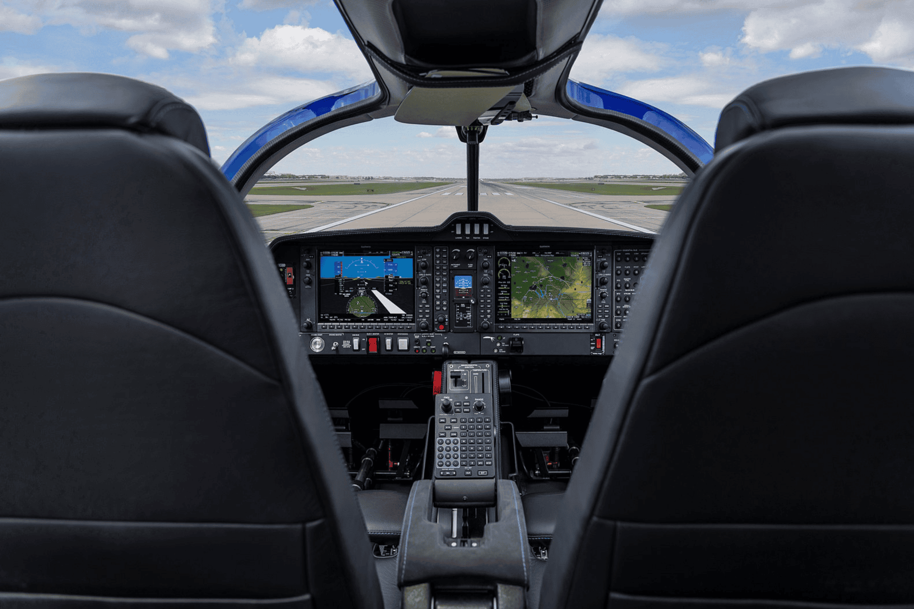 Aircraft cockpit with control panels and runway view