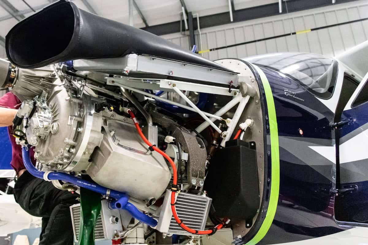 Blue and white Cessna airplane flying over water