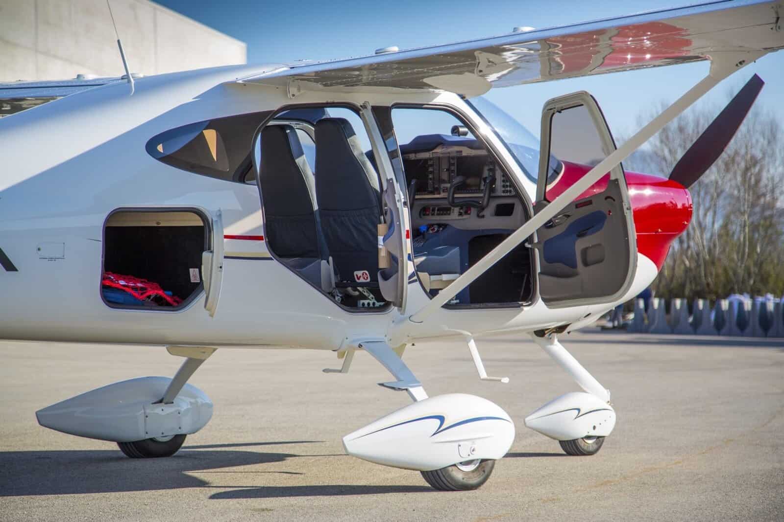 Blue and white Cessna airplane flying over water