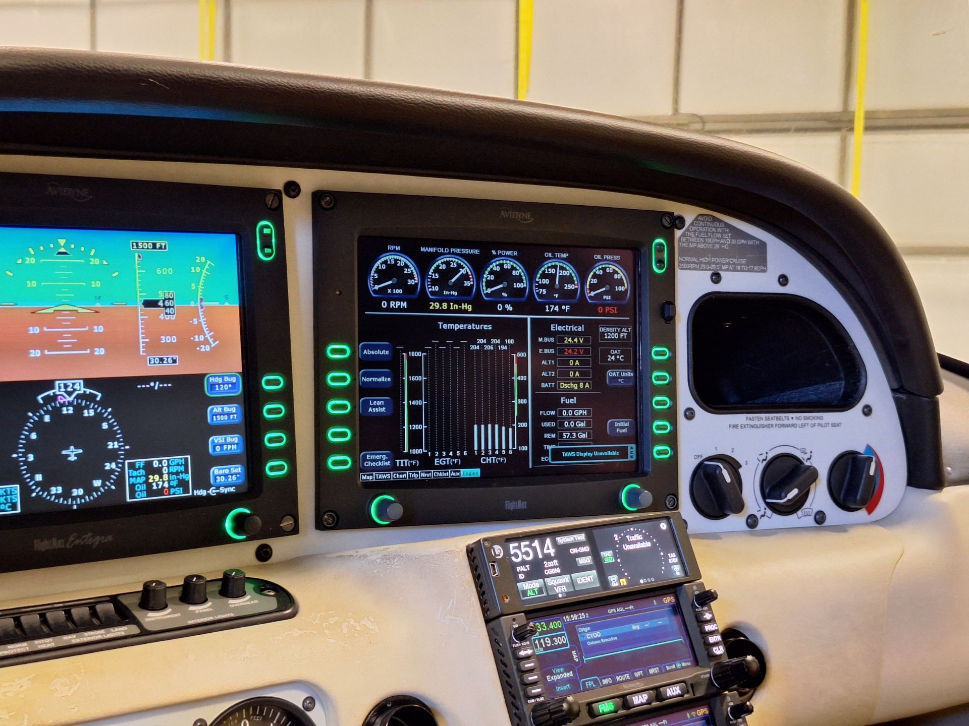 Pilot's cockpit panel with multiple colorful screens showing flight instruments and engine data, plus green backlit controls