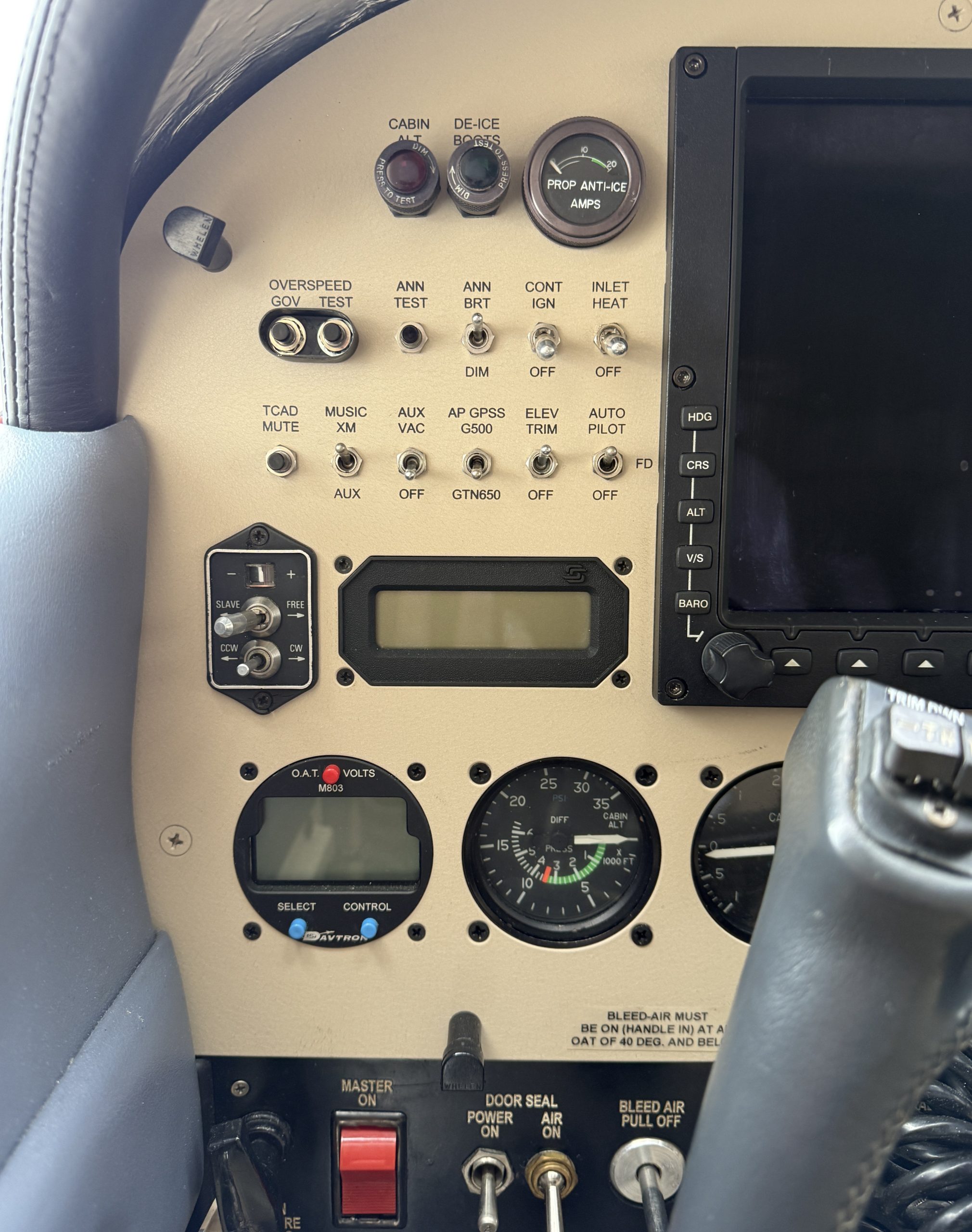 Close up of a airplane cockpit panel with switches labeled for cabin alt de ice prop anti ice and various test and control toggles