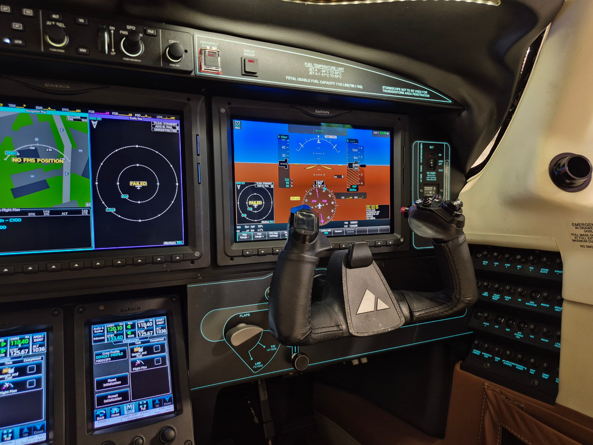 Cockpit of a small airplane with multiple Garmin avionics screens, flight instruments, and a yoke in the foreground.