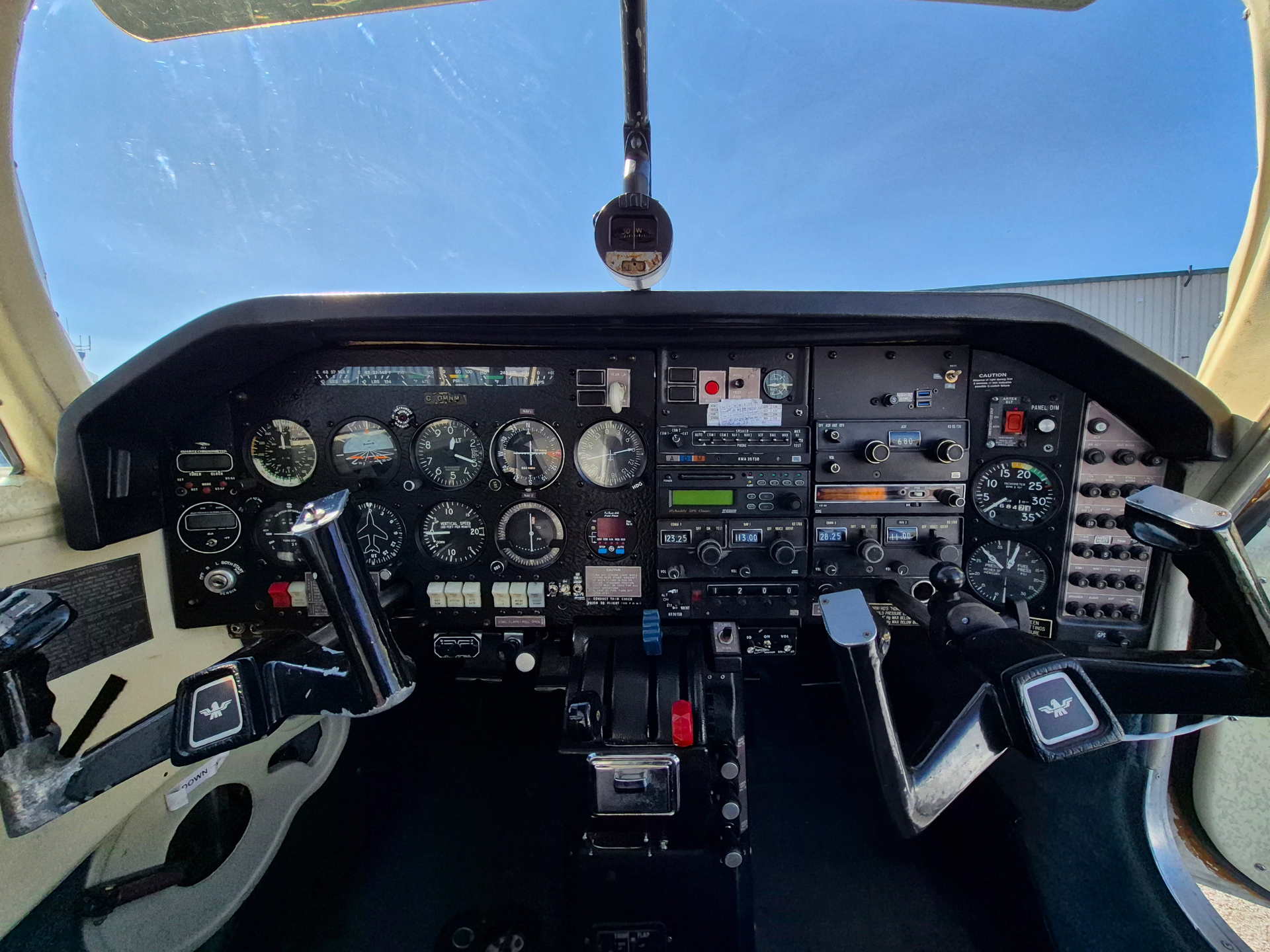 Pilot's cockpit interior showing flight instruments, gauges, and controls on the instrument panel.