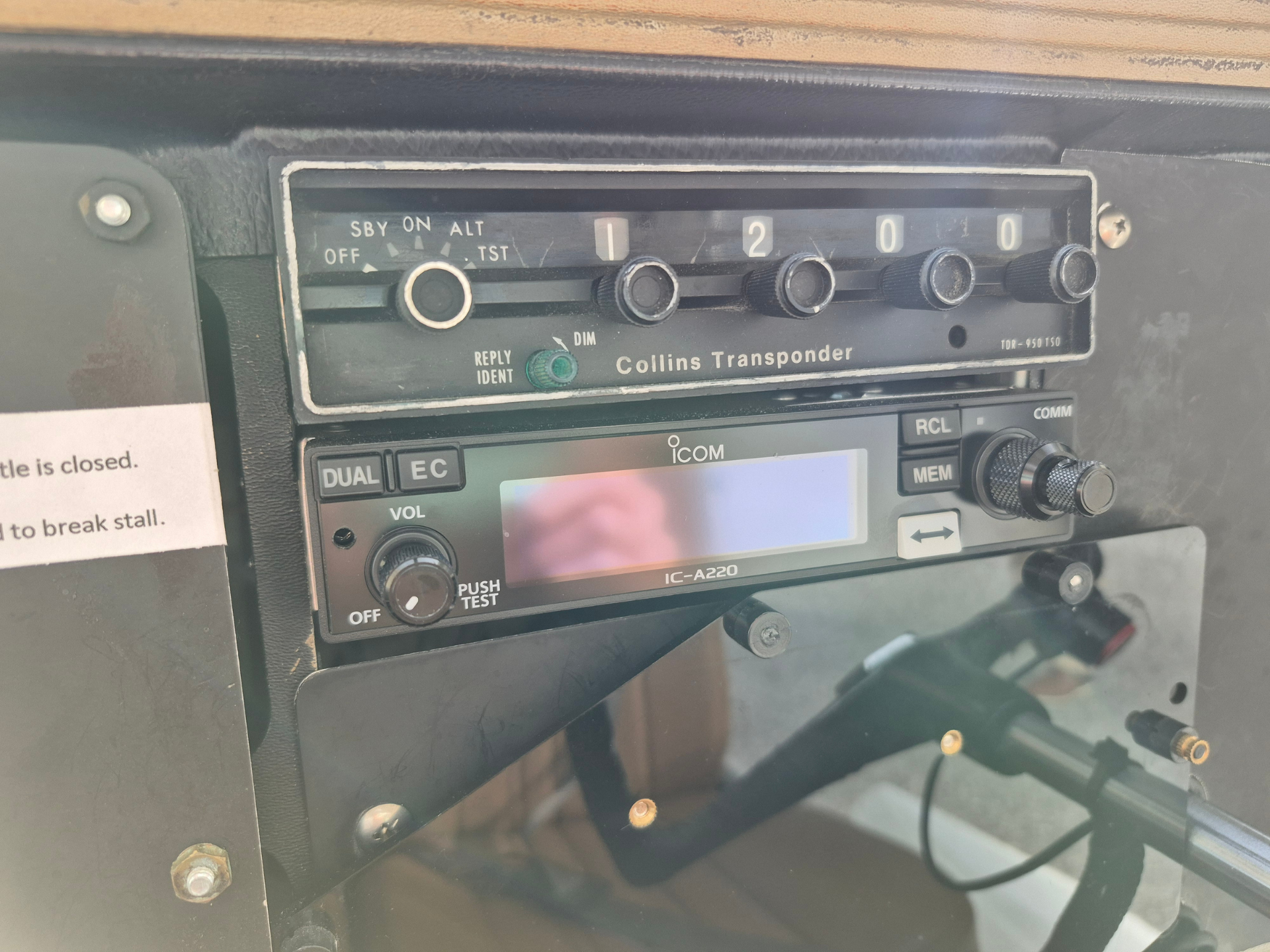 Close-up of a vintage Collins Transponder avionics panel with five numbered knobs and a green IDENT/REPLY switch labeled on the left side.