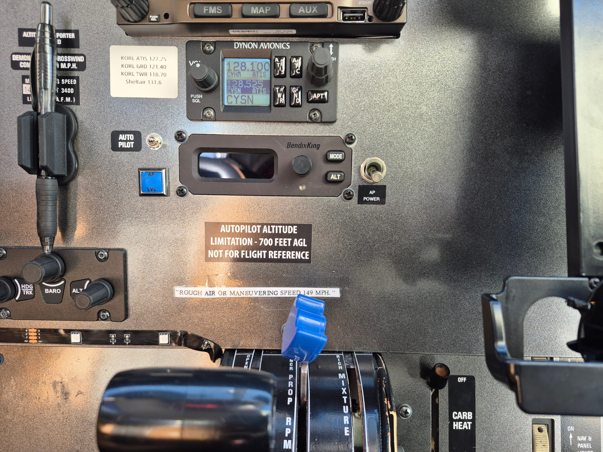 Close-up of aircraft cockpit panel showing BendixKing autopilot controls, blue digital display, and surrounding switches and labels.