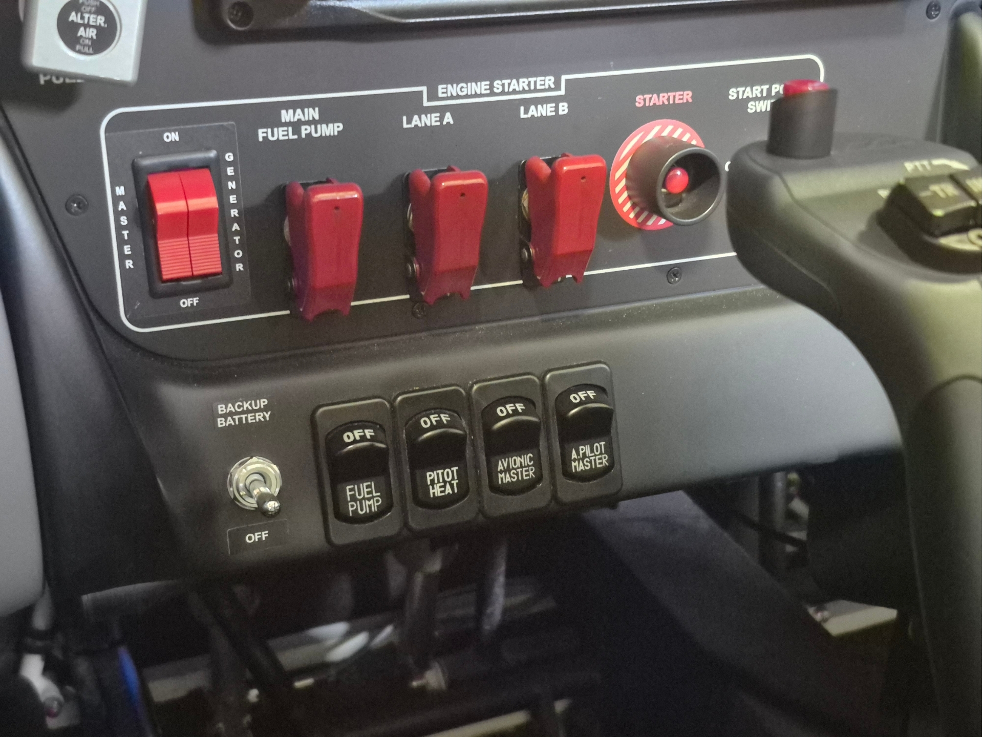 Cockpit panel with red toggle switches labeled Main Fuel Pump and Engine Starter, plus a red starter knob on the right side of the panel.