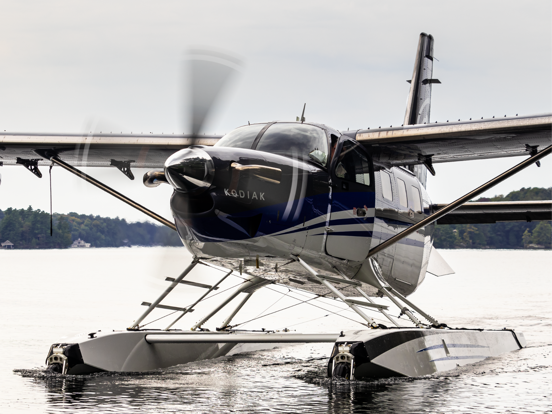 Close up of a Kodiak seaplane on water propeller spinning nose and cockpit visible